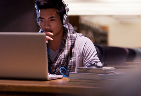 man with headphones looking at screen