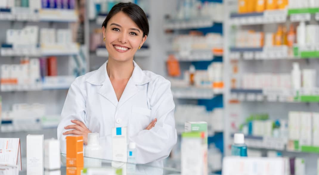 pharmacy assistant in front of wall